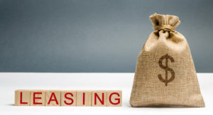 Leasing spelt in block letters beside a sack filled with money